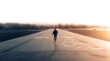 A Meditation for Moving On man walking down airport runway