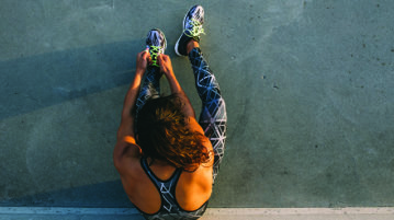 Take a Mindful Moment: 5 Simple Practices for Daily Life Woman tying shoes