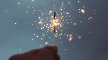 Passion Will Spark Your Resolutions, Not Pressure hand holding a sparkler