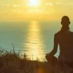 Can Meditation Lead to Lasting Change? woman meditating by the sea