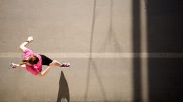 Mindful Running: Two Ways to Plan Your Route woman running on street, aerial view